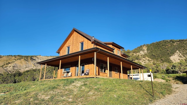 rear view of house featuring a mountain view