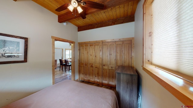 bedroom featuring beamed ceiling, ceiling fan, wood ceiling, and wood finished floors