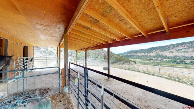 view of stable with a mountain view and a rural view