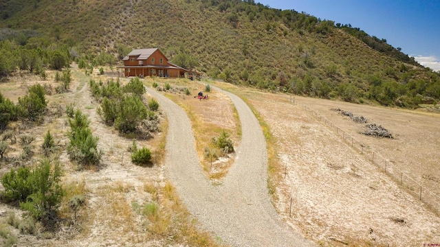 aerial view featuring a rural view and a wooded view