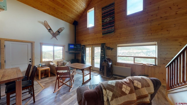 living room featuring high vaulted ceiling, wood walls, a healthy amount of sunlight, and wood ceiling