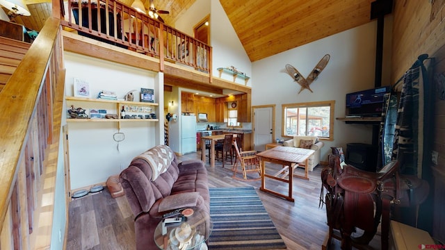 living area with high vaulted ceiling, wooden ceiling, and wood finished floors