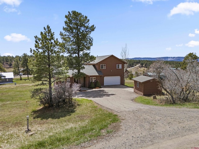 view of property exterior with a lawn, a garage, and driveway