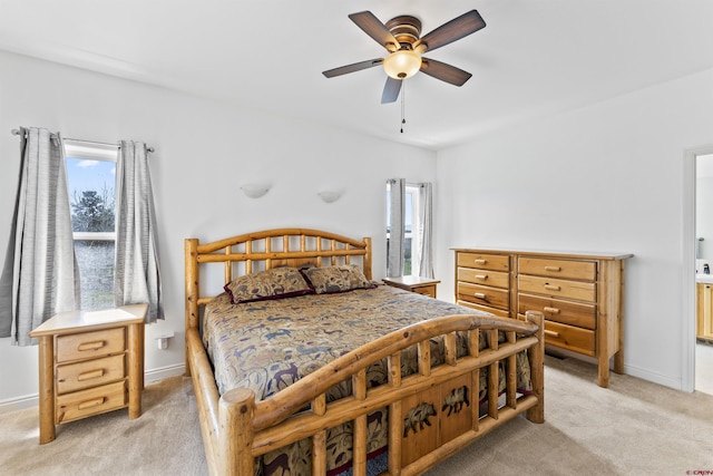 bedroom with baseboards, ceiling fan, and light carpet