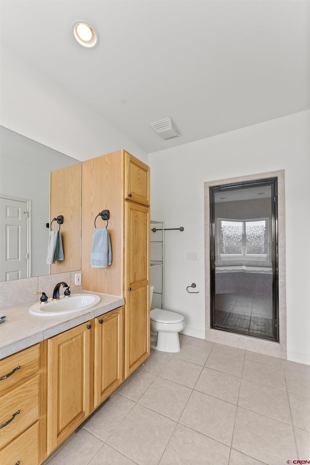 bathroom featuring tile patterned floors, vanity, toilet, and visible vents