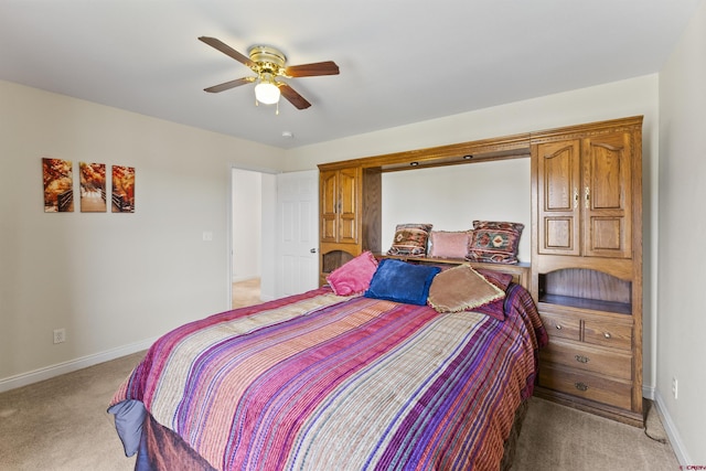 bedroom featuring baseboards, light carpet, and ceiling fan