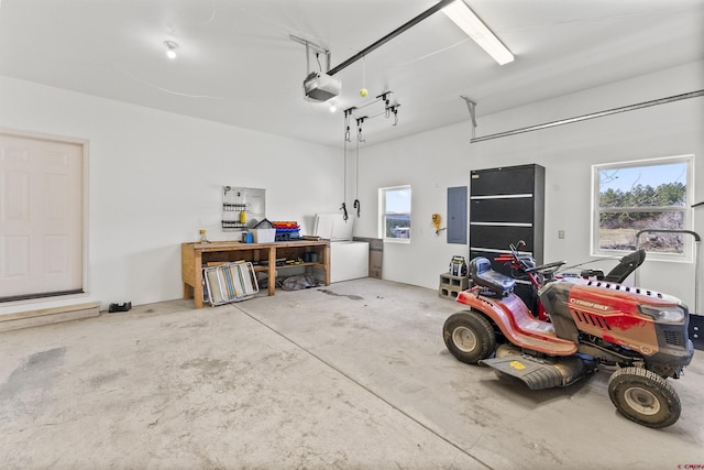 garage with a garage door opener and electric panel