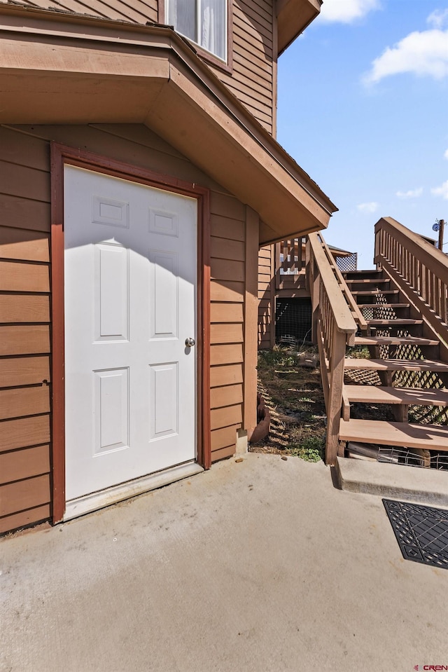 view of exterior entry with a patio