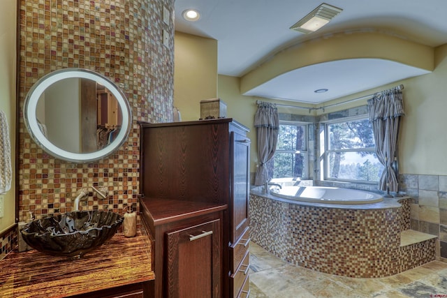 full bath with a garden tub, a sink, visible vents, and recessed lighting