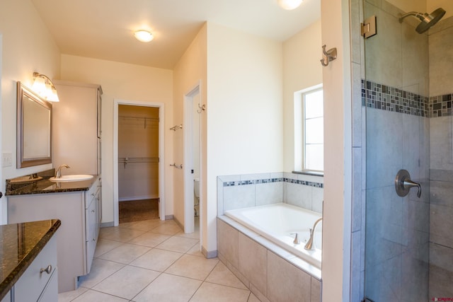 1010 N 11th St, Gunnison, CO 81230 - full bath featuring vanity, a bath, tile patterned flooring, and a tile shower