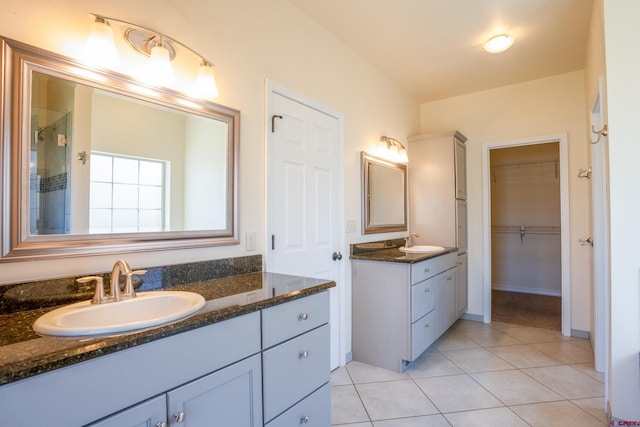 1010 N 11th St, Gunnison, CO 81230 - full bath featuring a sink, a spacious closet, tile patterned flooring, and two vanities