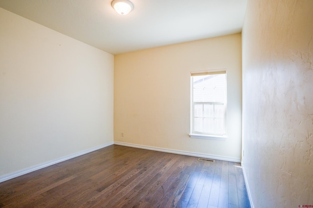 1010 N 11th St, Gunnison, CO 81230 - unfurnished room with baseboards, visible vents, and dark wood-type flooring