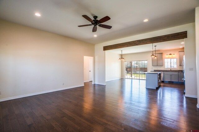 1010 N 11th St, Gunnison, CO 81230 - unfurnished living room with baseboards, ceiling fan, and dark wood-type flooring