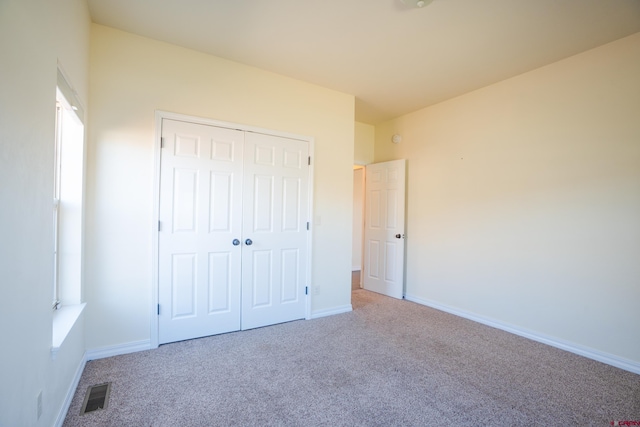 1010 N 11th St, Gunnison, CO 81230 - unfurnished bedroom featuring a closet, baseboards, carpet flooring, and visible vents