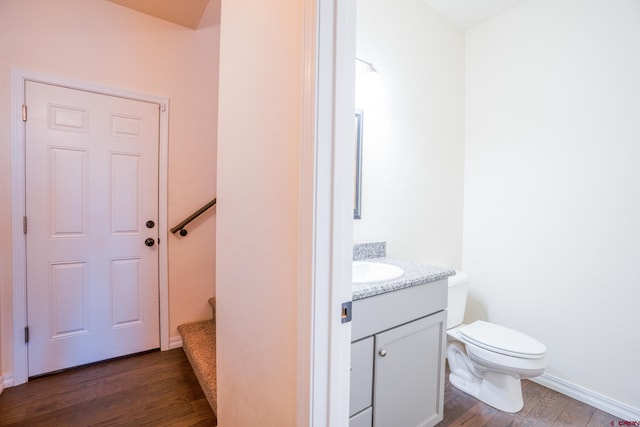 1010 N 11th St, Gunnison, CO 81230 - bathroom with vanity, baseboards, toilet, and wood finished floors