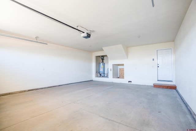 1010 N 11th St, Gunnison, CO 81230 - garage featuring water heater, baseboards, and a garage door opener
