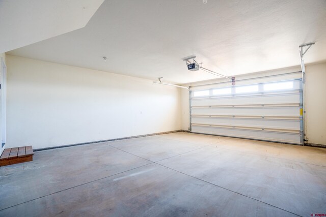 1010 N 11th St, Gunnison, CO 81230 - garage featuring baseboards and a garage door opener
