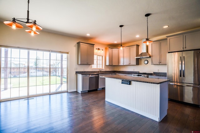 1010 N 11th St, Gunnison, CO 81230 - kitchen with wall chimney range hood, a center island, stainless steel appliances, recessed lighting, and dark wood-style floors