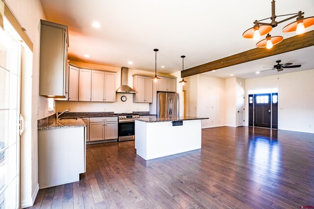 1010 N 11th St, Gunnison, CO 81230 - kitchen featuring appliances with stainless steel finishes, a center island, dark wood-style floors, recessed lighting, and wall chimney exhaust hood