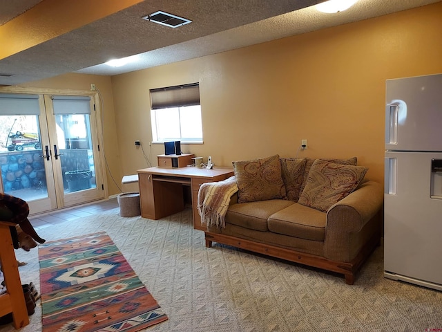 living area featuring visible vents, a textured ceiling, light carpet, and french doors