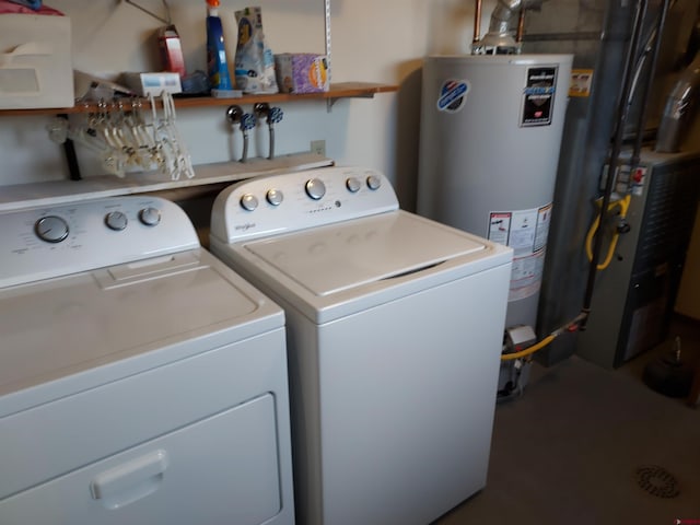 laundry area with laundry area, water heater, and washing machine and clothes dryer