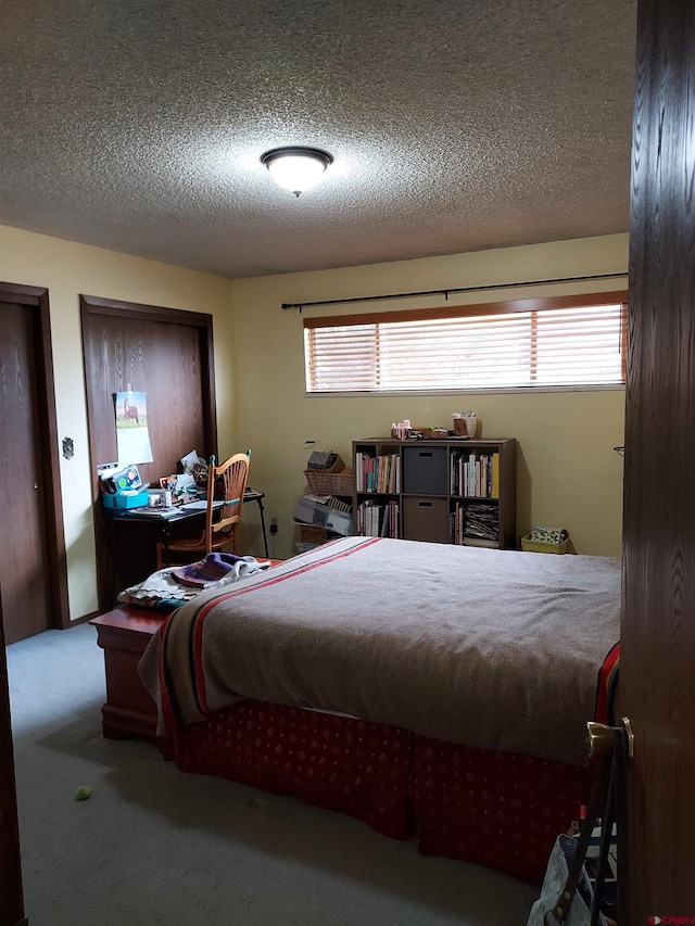 carpeted bedroom featuring a textured ceiling