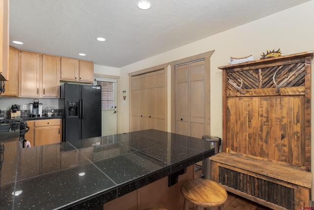 746 W Vallecito Crk, Bayfield, CO 81122 - kitchen with light brown cabinetry, a kitchen breakfast bar, recessed lighting, a peninsula, and black appliances