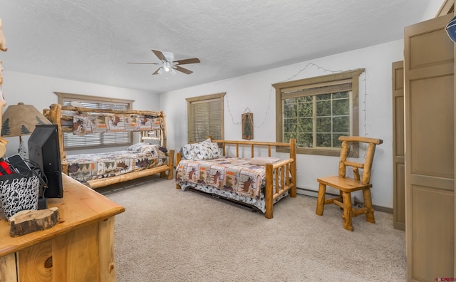 746 W Vallecito Crk, Bayfield, CO 81122 - bedroom featuring carpet, a ceiling fan, a baseboard heating unit, and a textured ceiling