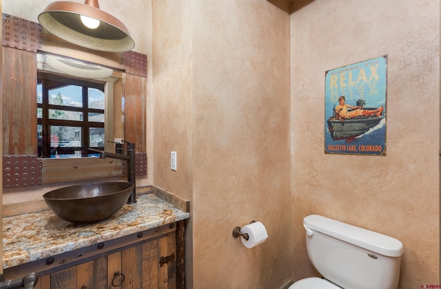 746 W Vallecito Crk, Bayfield, CO 81122 - bathroom with vanity, a textured wall, and toilet