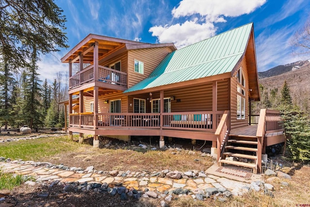 746 W Vallecito Crk, Bayfield, CO 81122 - back of house featuring a deck with mountain view, a balcony, log veneer siding, and metal roof