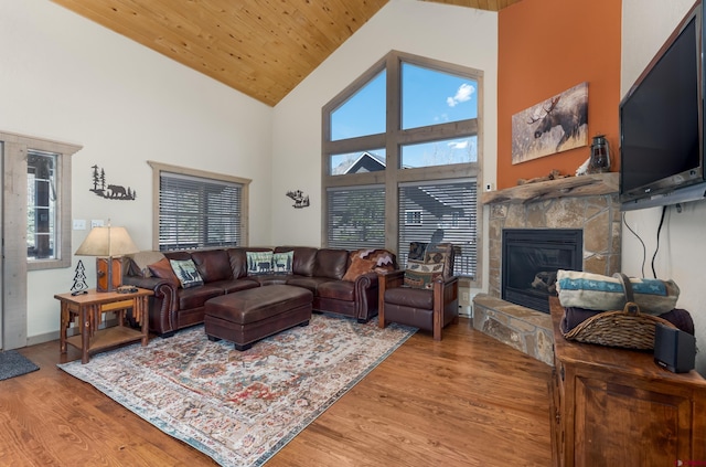 746 W Vallecito Crk, Bayfield, CO 81122 - living area with high vaulted ceiling, light wood-type flooring, a stone fireplace, and a wealth of natural light