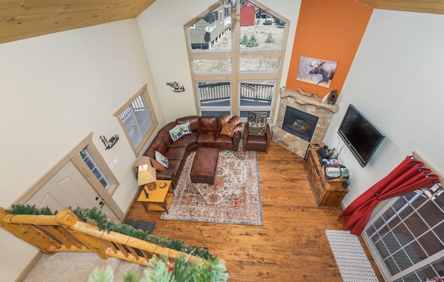 746 W Vallecito Crk, Bayfield, CO 81122 - living room with a high ceiling, a stone fireplace, and wood finished floors