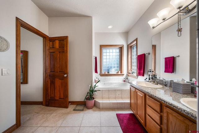 500 Dove Ranch Rd, Bayfield, CO 81122 - bathroom with double vanity, a garden tub, a sink, tile patterned floors, and baseboards