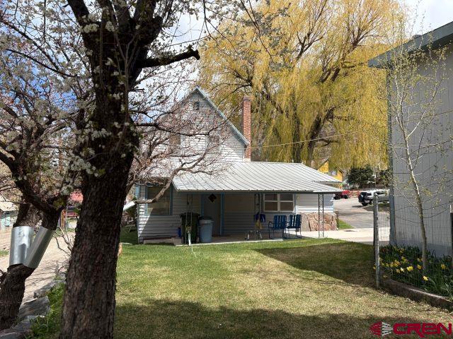 231 3rd Ave, Ouray, CO 81427 - rear view of house featuring a yard and covered porch