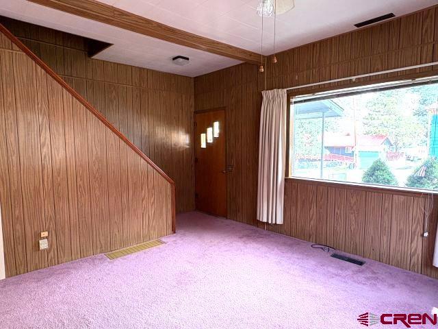 231 3rd Ave, Ouray, CO 81427 - interior space with beamed ceiling, wood walls, and visible vents