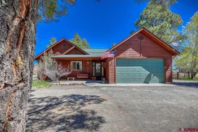 26 Steamboat Dr, Pagosa Springs, CO 81147 - view of front facade with an attached garage, covered porch, and driveway