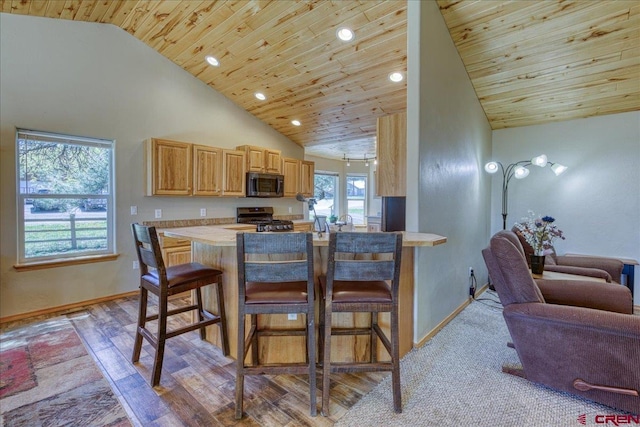 26 Steamboat Dr, Pagosa Springs, CO 81147 - kitchen featuring a kitchen breakfast bar, stainless steel microwave, wooden ceiling, and range