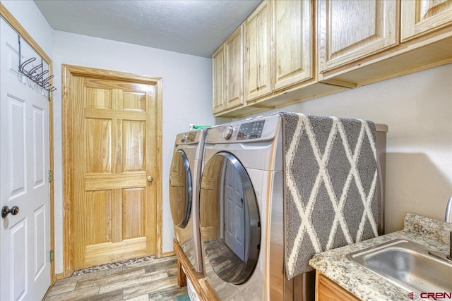 26 Steamboat Dr, Pagosa Springs, CO 81147 - clothes washing area featuring separate washer and dryer, a sink, cabinet space, and light wood finished floors