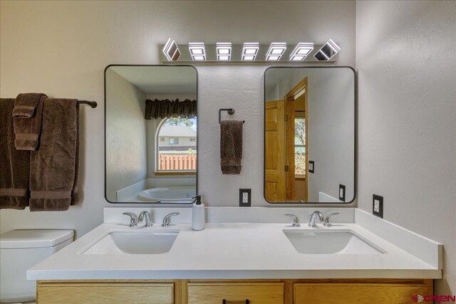 26 Steamboat Dr, Pagosa Springs, CO 81147 - full bath featuring double vanity, a sink, a bathing tub, and toilet
