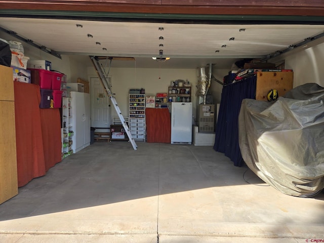26 Steamboat Dr, Pagosa Springs, CO 81147 - garage with freestanding refrigerator and a garage door opener