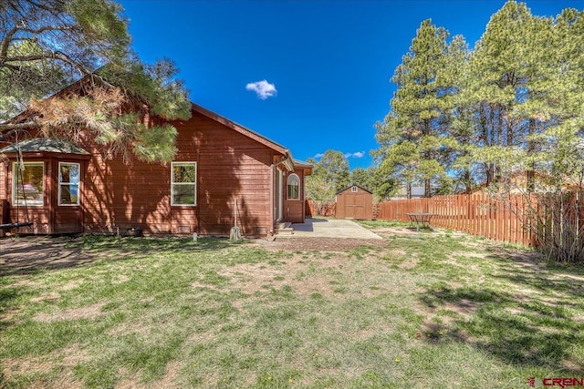 26 Steamboat Dr, Pagosa Springs, CO 81147 - rear view of property with a storage shed, a lawn, fence, and an outdoor structure
