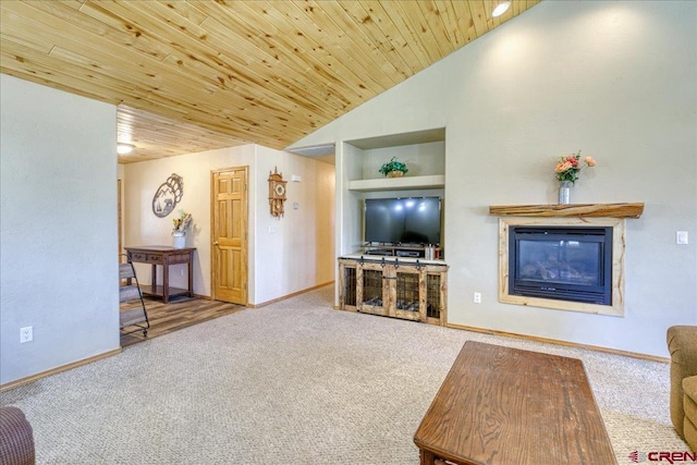 26 Steamboat Dr, Pagosa Springs, CO 81147 - carpeted living area featuring built in features, vaulted ceiling, baseboards, wooden ceiling, and a glass covered fireplace