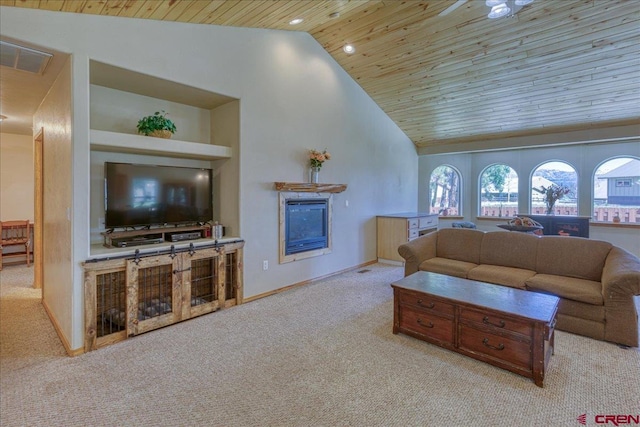 26 Steamboat Dr, Pagosa Springs, CO 81147 - living area with a glass covered fireplace, wooden ceiling, plenty of natural light, and carpet flooring