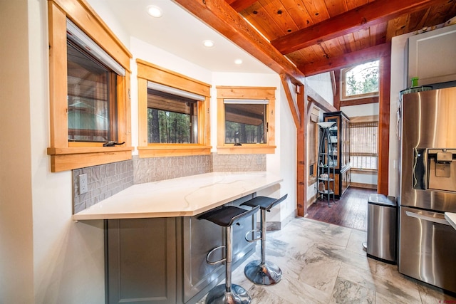 1215 Beaver Creek Dr, Bayfield, CO 81122 - kitchen with stainless steel fridge with ice dispenser, tasteful backsplash, beamed ceiling, and a wealth of natural light