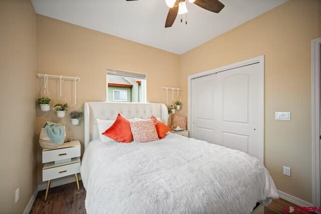bedroom with baseboards, a closet, and wood finished floors