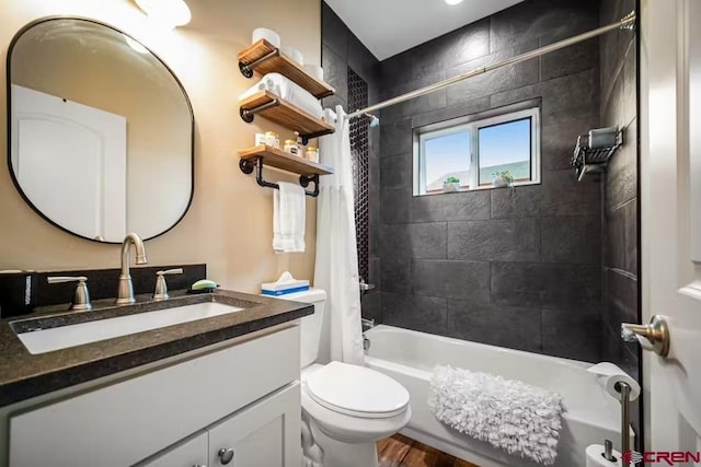 bathroom featuring vanity, shower / bath combo, and toilet
