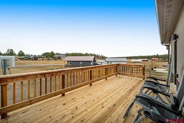 wooden terrace featuring a residential view