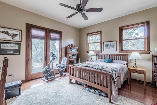 35900 Rd J.8, Mancos, CO 81328 - bedroom featuring access to exterior, wood finished floors, multiple windows, and baseboards
