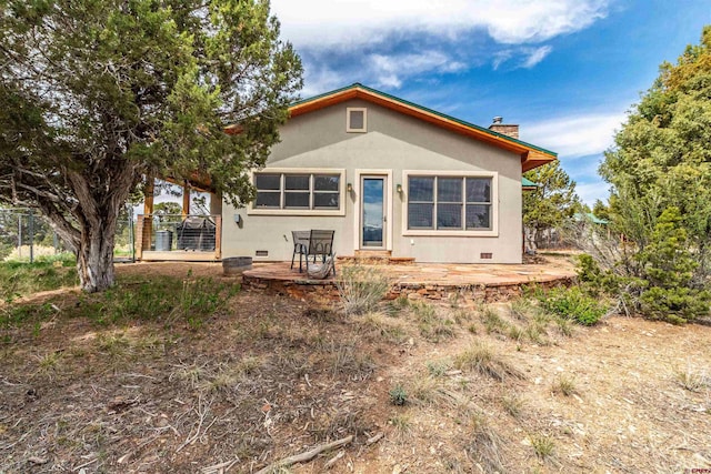 35900 Rd J.8, Mancos, CO 81328 - back of house featuring stucco siding, a chimney, and crawl space