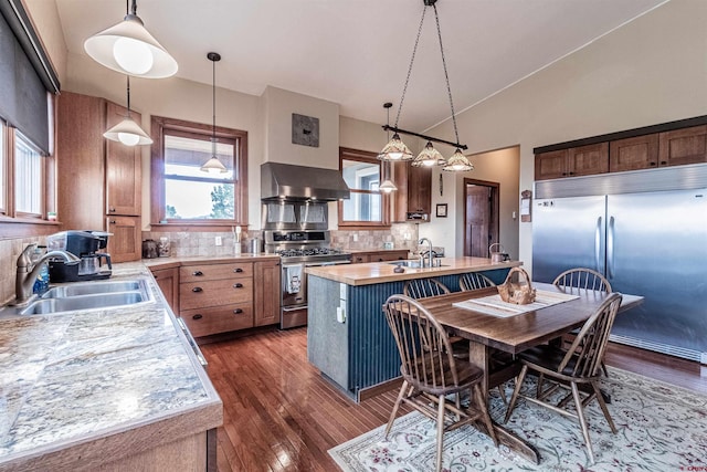 35900 Rd J.8, Mancos, CO 81328 - kitchen with stainless steel appliances, wall chimney exhaust hood, a sink, light countertops, and lofted ceiling
